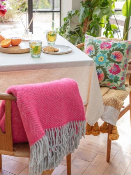 A selection of National Trust homeware, including multi coloured cushion and fascia throws