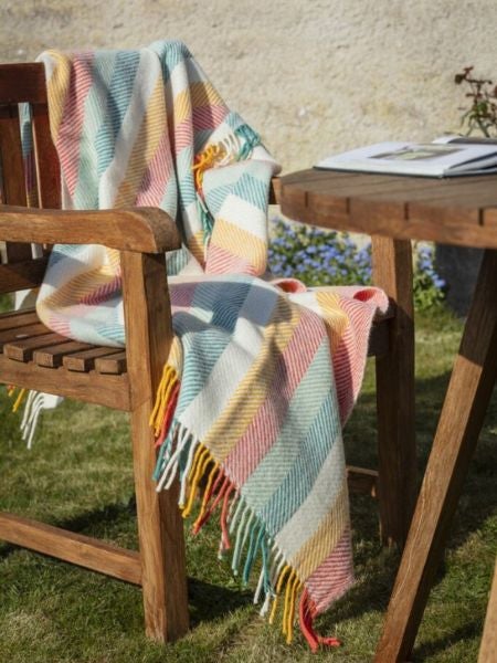 National Trust multicolour striped throw on a wooden chair
