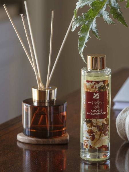 National Trust orange and cedarwood reed diffuser in a burnt orange glass