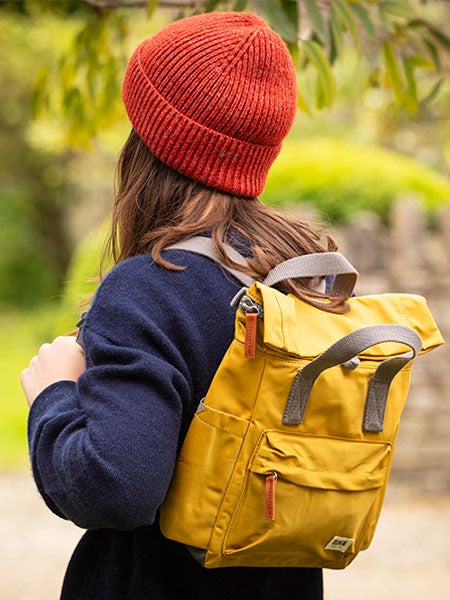 Woman on a National Trust waterproof green check picnic blanket. 