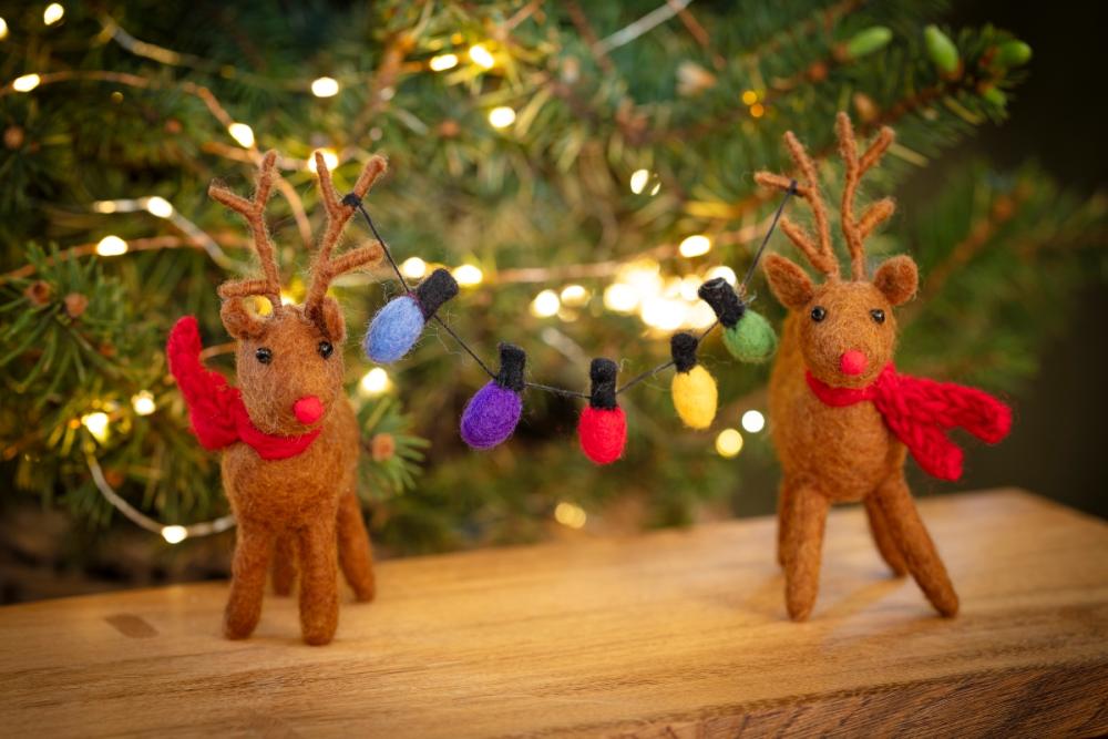 National Trust felt handmade reindeer decorations with felt fairy lights hung from their antlers
