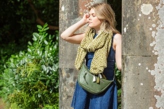 Scarves - image shows model wearing the Hinton Ampner inspired scarf from the new National Trust autumn winter range.
