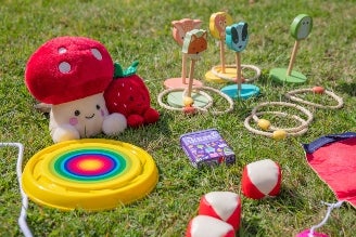 Children's games - image shows selection of toys and games from the National Trust children's range, including Squirrel Jump the board game, Jellycat soft toys Conker and Acorn, as well as the Match a Tree card game and Woodland Dominoes.