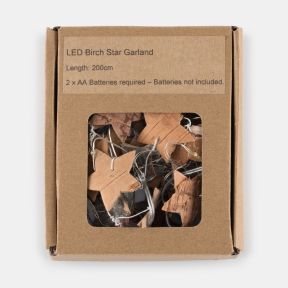 Kraft cardboard retail box containing an LED Birch Star Garland, displayed against a light background. The front of the box features a clear window revealing the garland inside, including natural birch wood star shapes attached to a silver wire string wit