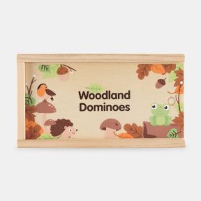 Wooden storage box for a woodland-themed dominoes game, displayed against a light background. The sliding lid features colourful illustrations of a robin perched on a mushroom, a frog, a hedgehog, mushrooms, acorns and autumn leaves surrounding the text “