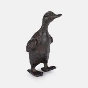 Small cast iron duck ornament with a rustic, textured finish and upright stance, featuring outstretched wings and webbed feet.