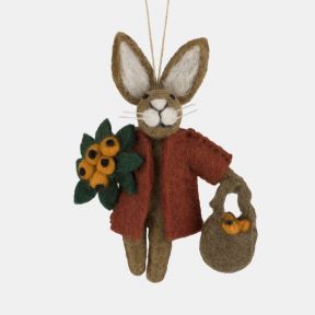 Felt rabbit hanging decoration crafted from brown wool, featuring a rust-coloured coat, a bouquet of orange berries and green leaves, and a small brown handbag filled with matching berries, suspended from a hanging loop and isolated on a white background.