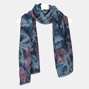 Abstract watercolor print scarf in shades of blue, teal and mauve, featuring a soft brushed texture, fringed edges, and long rectangular design draped on a hanger.