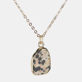 Gold-tone necklace with an irregular dalmatian jasper stone pendant, featuring a cream-toned natural stone design with black and warm beige speckled detailing on a fine link chain.