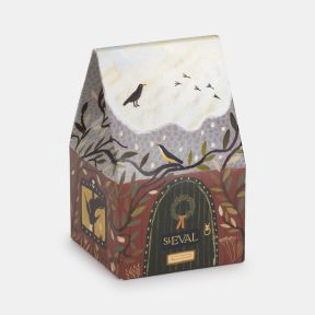 St Eval festive candle gift box featuring illustrated woodland birds, winter foliage, and a snow-covered cottage scene, presented in decorative seasonal packaging with rich green, burgundy and cream tones.