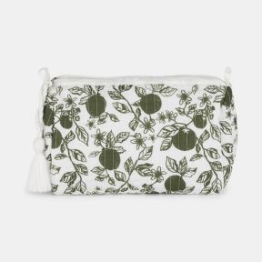 White quilted toiletry bag featuring a green orangery-inspired print with citrus fruit, leaves, and blossoms. The zip-top design includes a decorative white tassel pull and a softly structured shape, photographed against a light grey background.