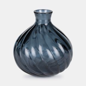 Glossy dark blue glass vase with a rounded bulb shape and narrow neck. Twisted ribbed detailing wraps around the body, creating a spiral effect. Decorative vase photographed on a light grey background with reflective finish and smooth texture.