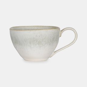 Speckled Mist Mug featuring a soft off-white reactive glaze with delicate speckled detailing and subtle mist-like tonal variations. Finished with a slender curved handle and gently tapered shape, this elegant stoneware mug brings a calm, contemporary feel