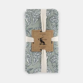 Set of four Kilburn & Scott napkins in soft sage green, featuring an elegant heritage-inspired floral pattern in white. Neatly folded and presented with a decorative sleeve, these fabric napkins combine timeless country charm with a muted colour palette,