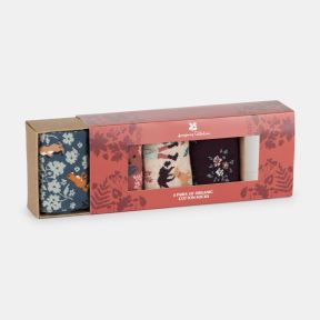 Organic cotton sock gift box featuring four pairs of patterned socks with floral, woodland animal and botanical designs, presented in a coral floral gift sleeve with a window display and kraft card packaging.