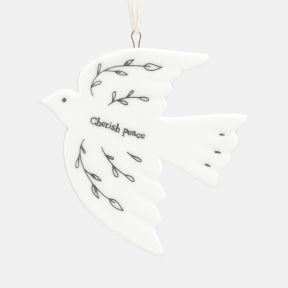 White ceramic dove Christmas hanging decoration shown in a close-up view, featuring delicate black botanical line illustrations, the words “Cherish peace”, a smooth glazed finish, and a cream hanging ribbon for festive seasonal décor.