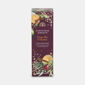 Christmas Wreath luxury hand cream in a burgundy gift box decorated with dried orange slices, cinnamon sticks, berries, greenery and gold accents. Orange, clove and cinnamon fragrance with shea butter, aloe vera and vitamin E. Made in England.