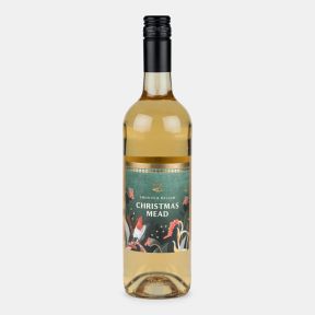 Bottle of Christmas mead with a festive illustrated label featuring a robin, winter foliage and berries, presented on a light grey background.