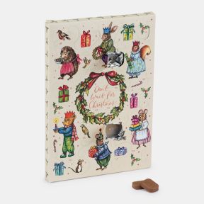 Chocolate advent calendar with festive illustrations of woodland animals, wrapped gifts and a Christmas wreath, displayed with two milk chocolate pieces.