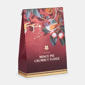 Festive confectionery gift box in red seasonal packaging featuring a bird, decorative botanical illustrations and gold accents, shown at an angled view.