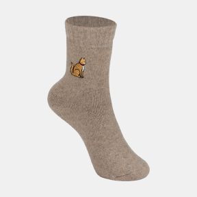 Light brown ankle sock with a soft marl texture and ribbed cuff, featuring an embroidered golden dog motif with a red collar on the outer ankle, displayed against a white background.