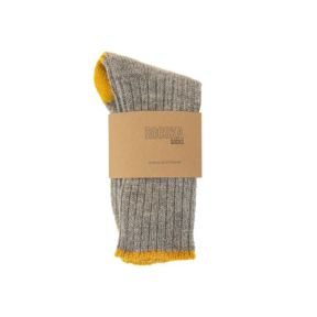 Grey ribbed Rooska socks with contrasting mustard yellow toe and cuff details, wrapped in a kraft paper band displaying the Rooska Socks branding, shown folded on a light grey background.