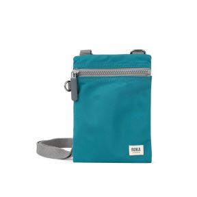 Teal crossbody pouch shown from the rear, featuring a grey adjustable shoulder strap and slip pocket on the back