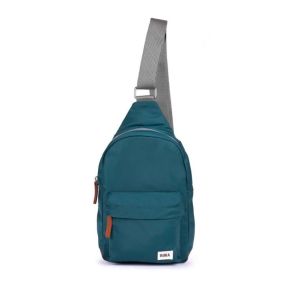 Teal sling backpack with a wide grey shoulder strap, front zip pocket, and brown zip pull tabs.