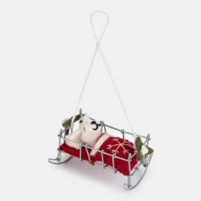 Felt Dalmatian puppy Christmas hanging decoration in a miniature silver-tone wire bed, featuring a white wool-effect puppy with black spots, embroidered facial details, a red felt blanket with white snowflake embroidery, holly accents, and a natural hangi