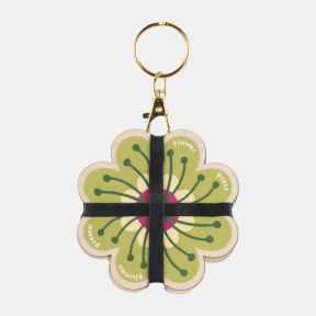 Blumen Pocket Flower Press keyring featuring a flower-shaped design with a vibrant green and pink botanical motif. Crafted from wooden panels with black elastic bands and attached to a gold-tone keyring clasp, this compact flower press is ideal for preser