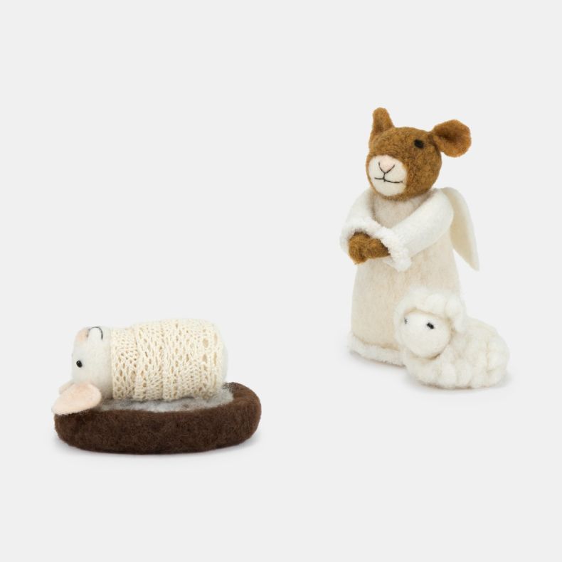 Handcrafted felt nativity scene figures displayed against a light background, featuring a brown and cream angel mouse dressed in a white robe with felt wings, standing beside a small white felt sheep. Alongside the angel is a baby mouse figure wrapped in 