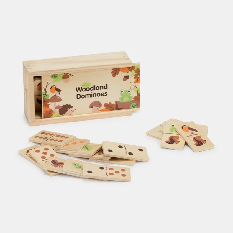 Woodland dominoes game set displayed against a light background, featuring a wooden storage box with a sliding lid and a collection of wooden domino tiles spread in front. The lid is illustrated with woodland-themed artwork including a robin, frog, hedgeh