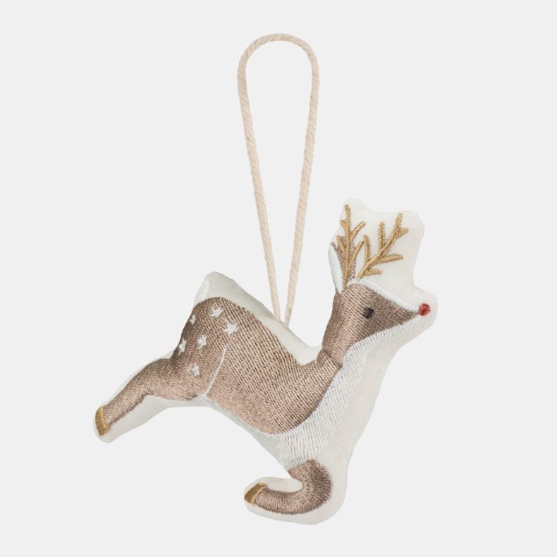Embroidered hanging reindeer decoration shown from a side angle, featuring soft taupe and cream fabric, stitched gold antlers, white embroidered spots, a red nose and gold hoof details, suspended from a fabric hanging loop and isolated on a white backgrou