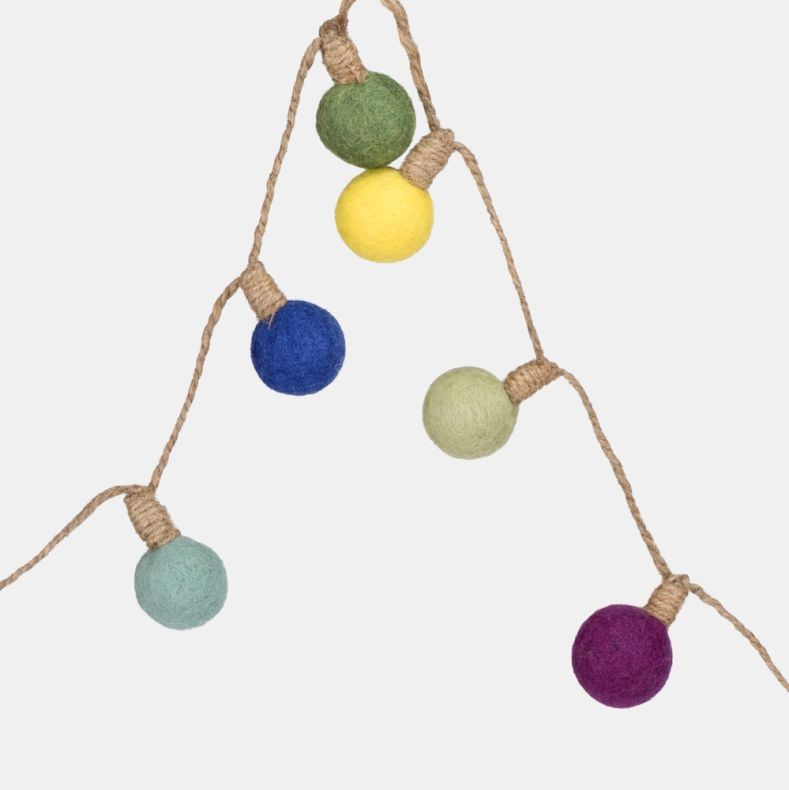 Close-up of a decorative garland featuring felt pom-pom ball lights in bright orange, pink, teal, pale green and blue, attached to natural twine. The colourful handcrafted design