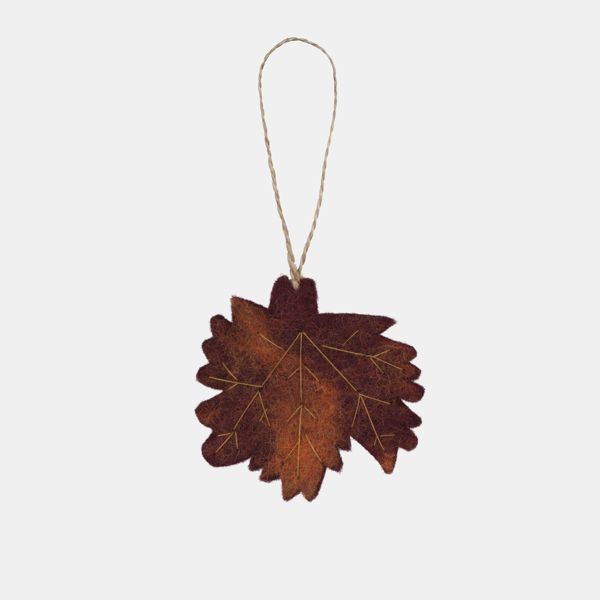 Autumn leaf hanging decoration displayed against a light background, featuring a maple-style leaf shape in rich shades of deep brown, burnt orange and burgundy with delicate printed vein detailing. Suspended from a natural twine loop, the decoration has a