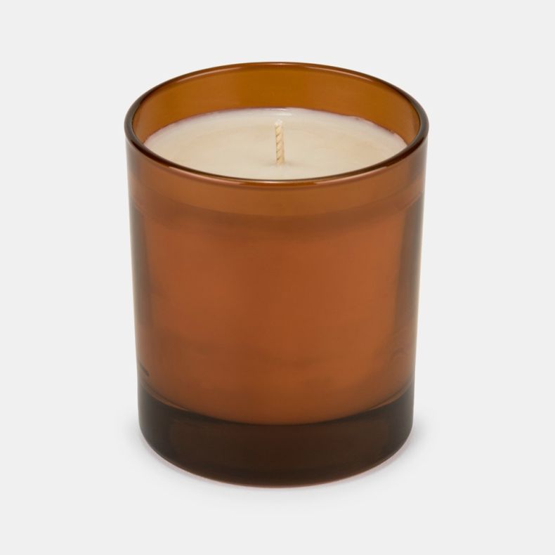Orange & Cedarwood scented candle in a translucent amber glass holder with a single centred wick and creamy wax, displayed against a light background.