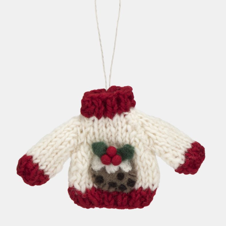White knitted Christmas jumper hanging decoration with red ribbed collar, cuffs and hem, featuring a festive Christmas pudding motif with white icing, holly leaves and red berry detailing, suspended from a white hanging loop.