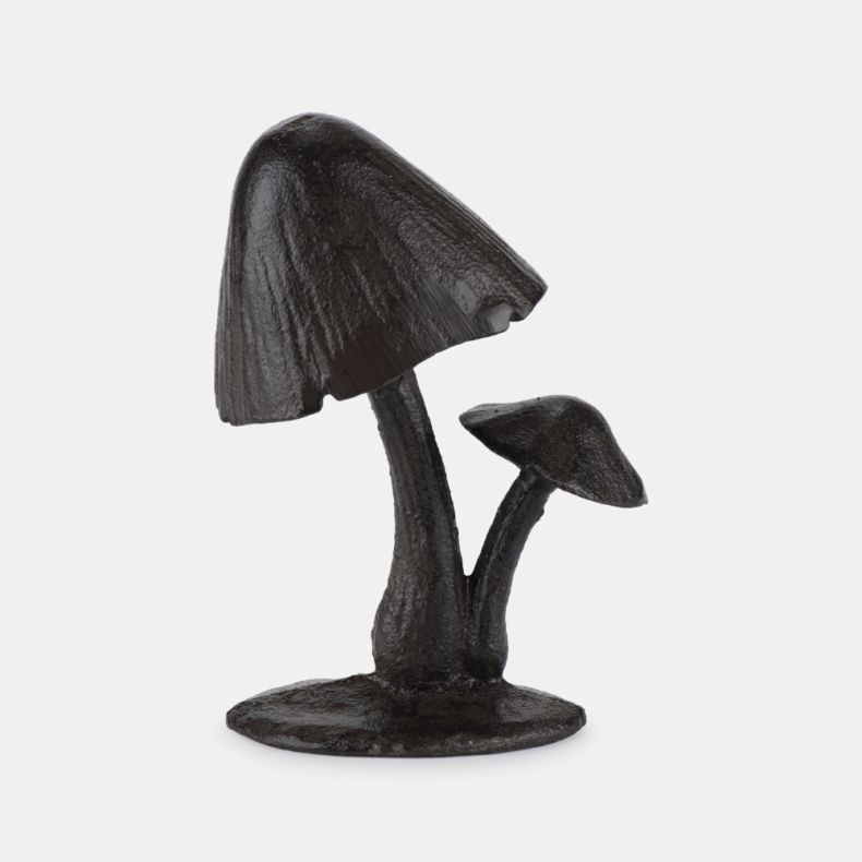 Cast iron mushroom sculpture shown from a reverse angle, featuring two mushrooms with textured stems and detailed domed caps, finished in a dark brown weathered patina and mounted on a solid base, isolated on a white background.