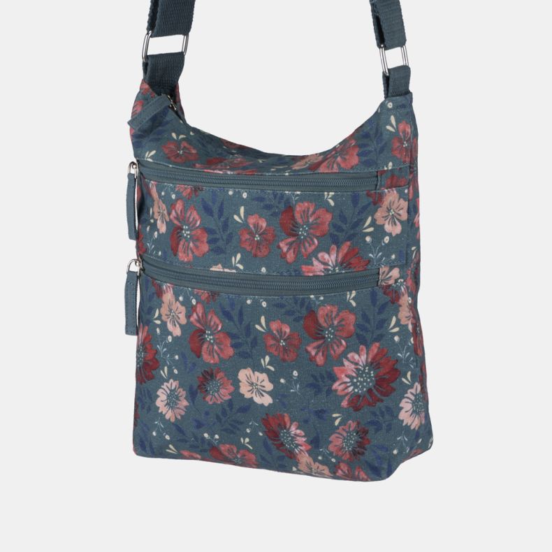 Blue floral crossbody bag with adjustable shoulder strap, dual front zip pockets, and all-over pink and red floral print shown from an angled side view.
