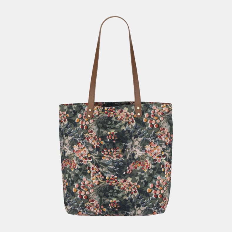 Floral print tote bag with tan shoulder straps and all-over botanical berry pattern.
