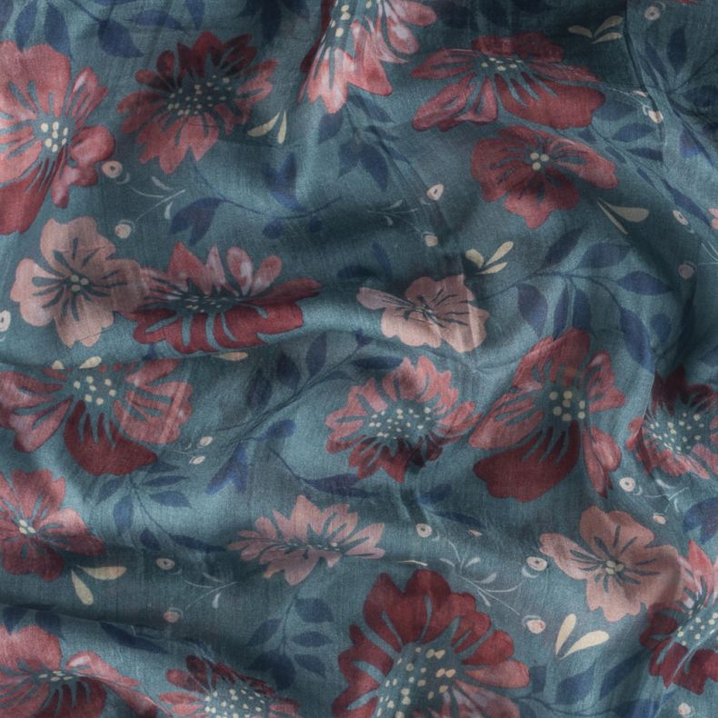 Close up of blue floral scarf with pink and red floral print