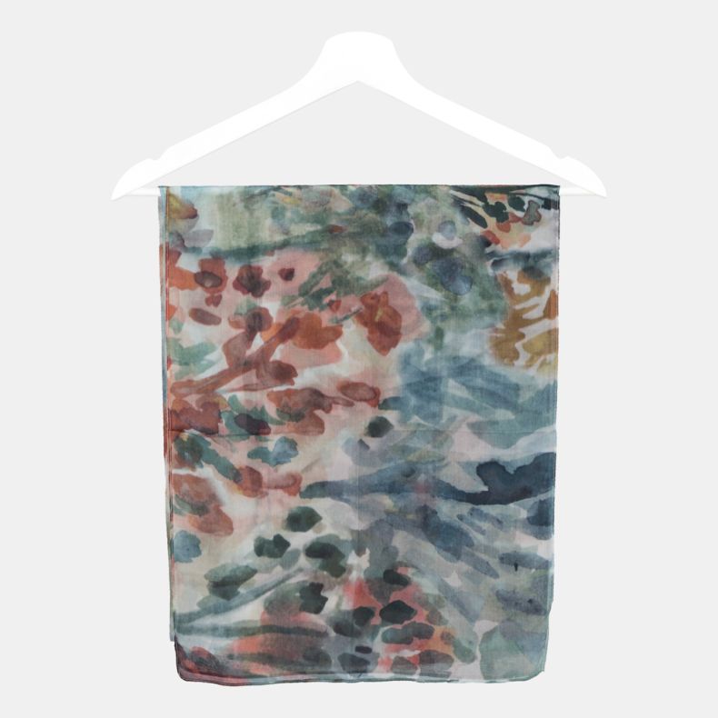 Abstract floral print scarf folded on a hanger, featuring soft blue, teal and coral watercolor-style floral patterns on lightweight semi-sheer fabric.