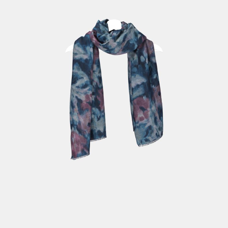 Abstract watercolor print scarf in shades of blue, teal and mauve, featuring a soft brushed texture, fringed edges, and long rectangular design displayed draped on a hanger.