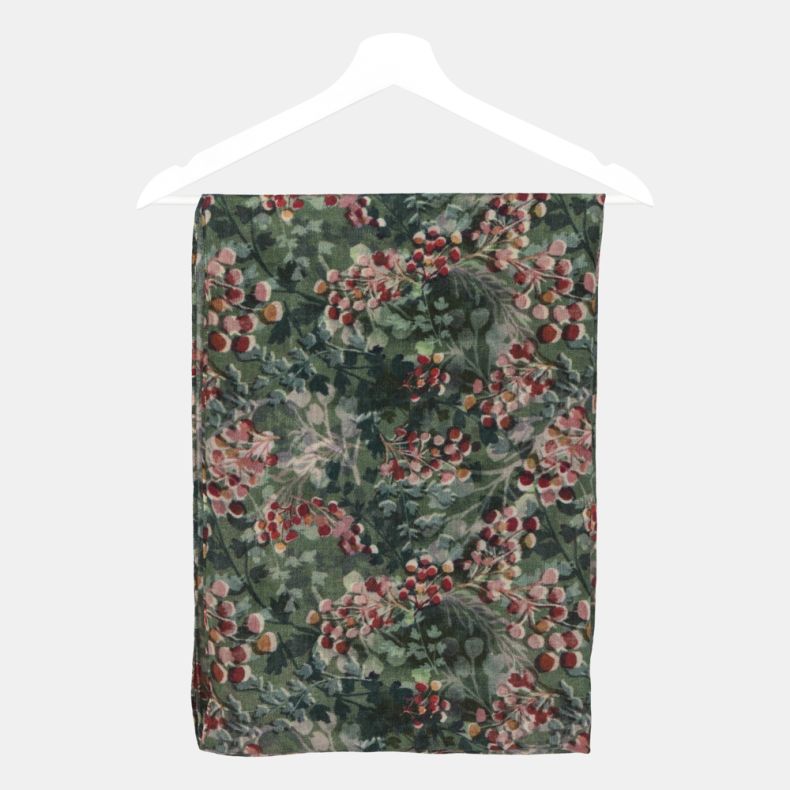 Green botanical print scarf folded on a hanger, featuring an all-over foliage and berry pattern in shades of green, red and pink on soft lightweight fabric.