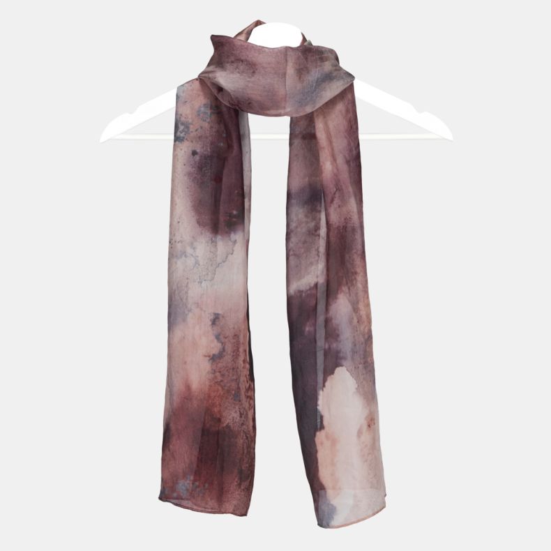 Abstract watercolor print scarf in blush pink, mauve and plum tones, featuring lightweight semi-sheer fabric and a long rectangular design draped on a hanger.