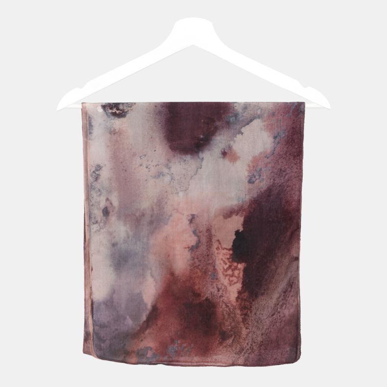Abstract watercolor print scarf in blush pink, mauve and plum tones, featuring lightweight semi-sheer fabric folded over a hanger.