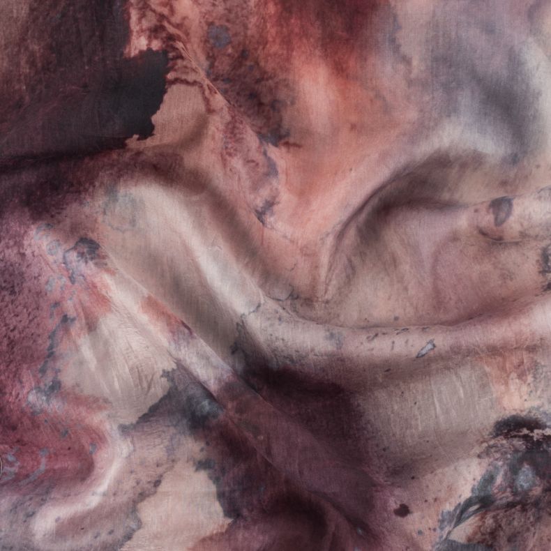 Close up of an abstract watercolor print scarf in blush pink, mauve and plum tones,