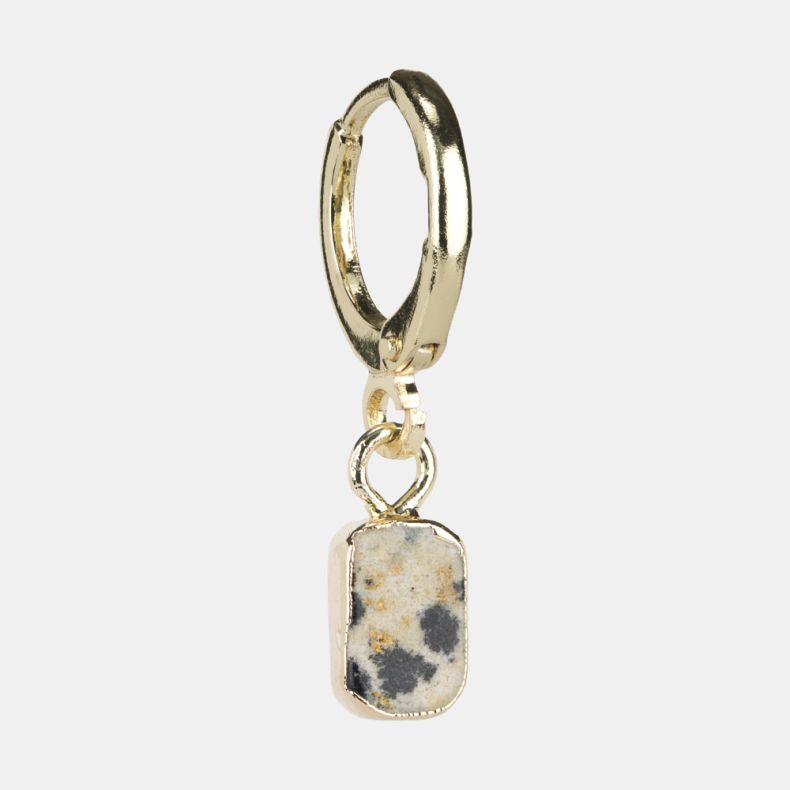 Gold-tone huggie hoop earring with a rectangular speckled stone drop charm, featuring a cream-toned natural stone design with grey and warm beige fleck detailing.