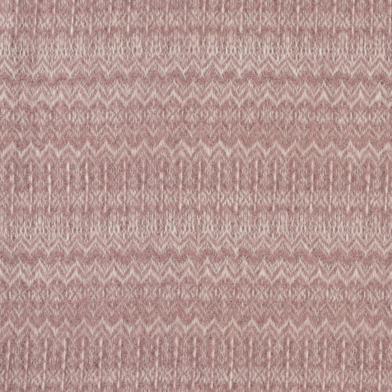 Close-up of a blush pink throw blanket featuring a soft woven texture and subtle geometric pattern. Delicate zigzag and diamond-inspired details create visual interest, while the cosy fabric finish highlights the blanket's warmth, comfort and decorative a