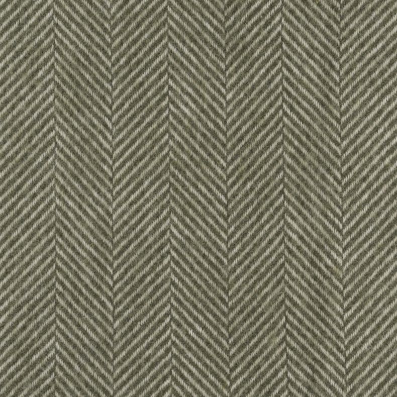 Close-up of a sage green throw blanket featuring a classic herringbone weave pattern. The soft, cosy fabric showcases a timeless chevron design with subtle texture and depth, making it a stylish and versatile addition to sofas, beds and living spaces.
